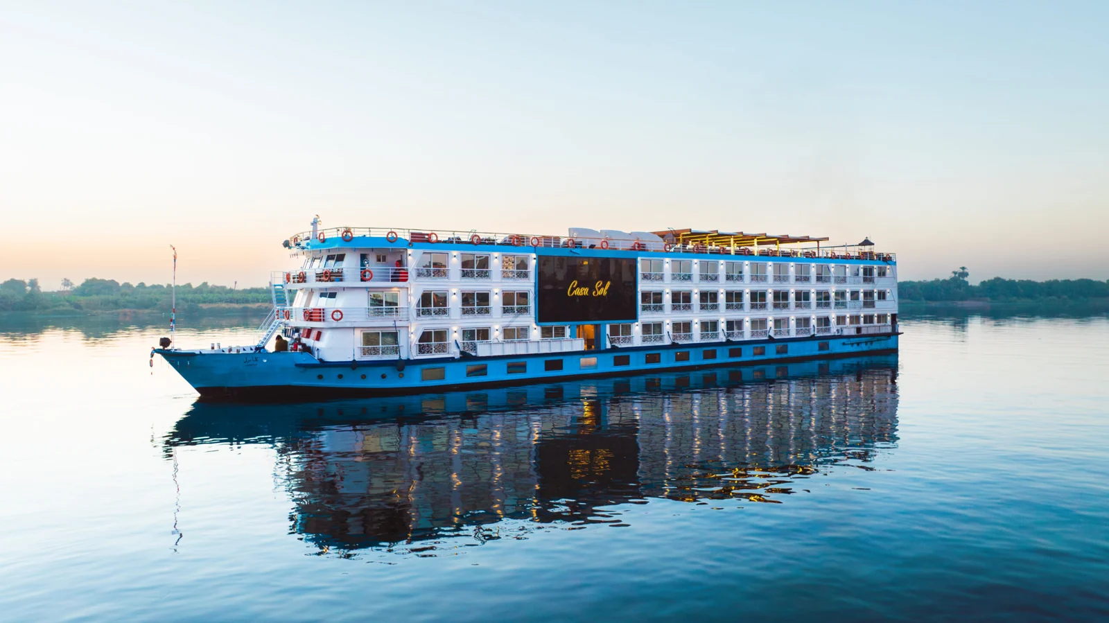 The blue and white Casa Sol cruise ship reflected on the Nile